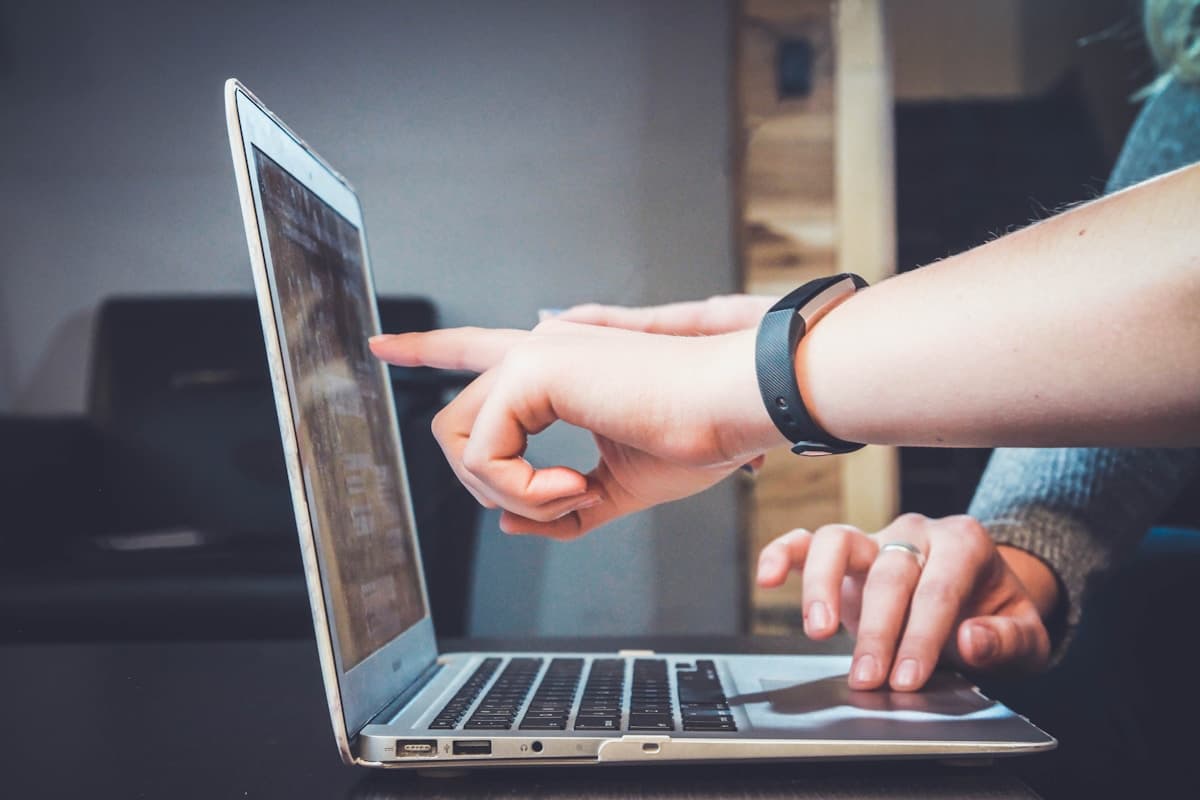 People collaborating on a laptop to answer a question