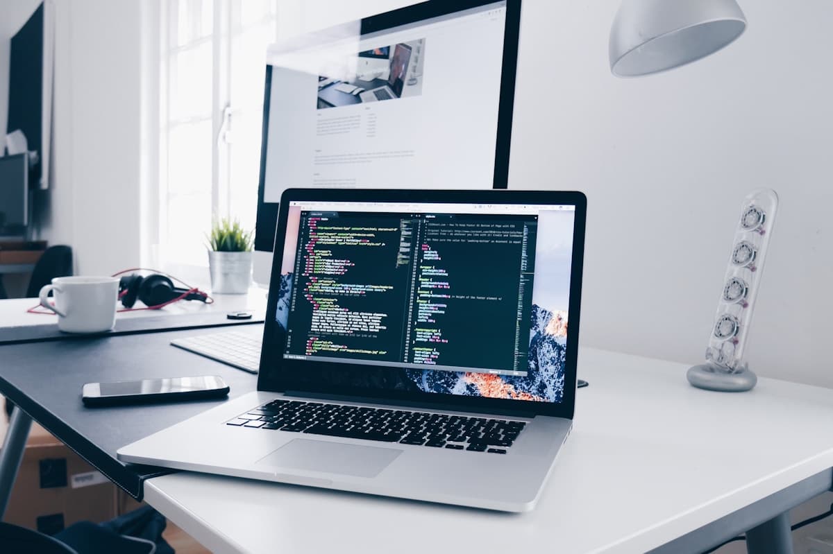 Web development workspace with a laptop displaying code